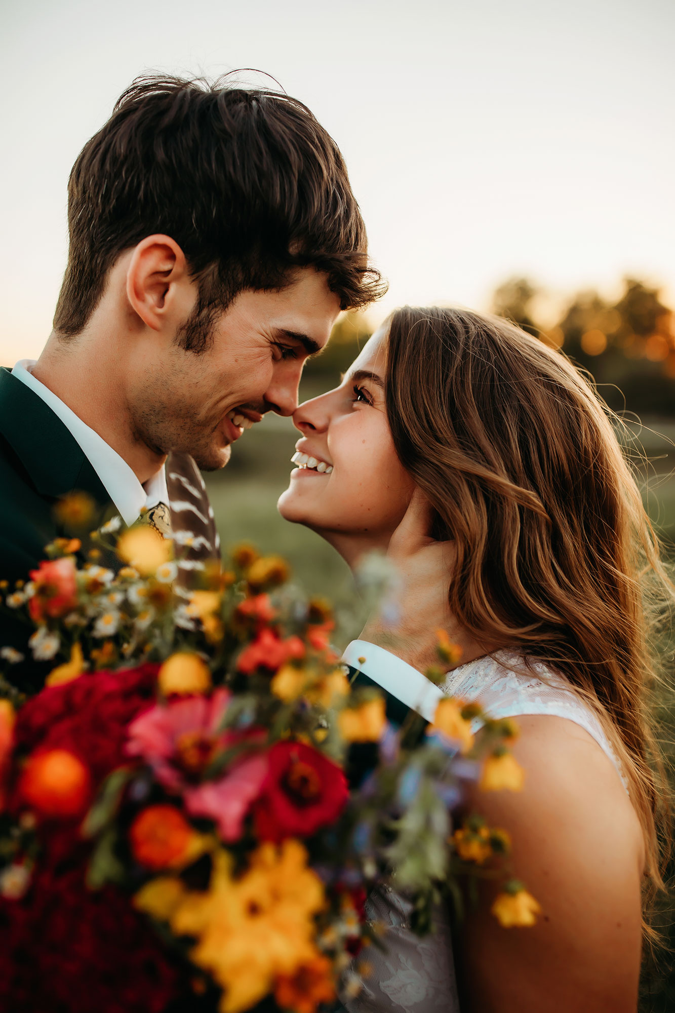 Happy couple on wedding day with colorful flowers